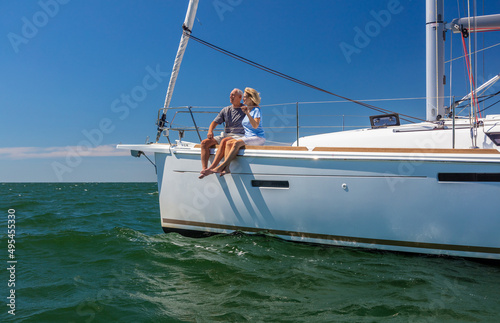 Luxury travel for senior couple sitting on yacht