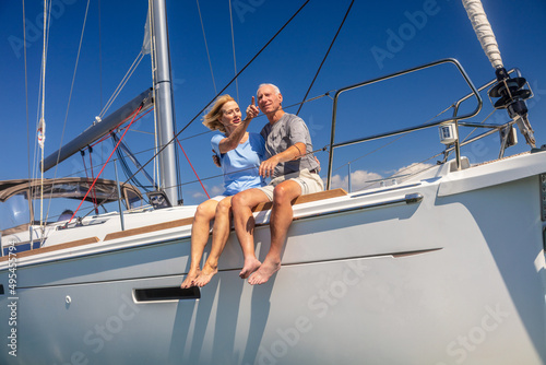 Senior couple enjoying healthy outdoor lifestyle on yacht