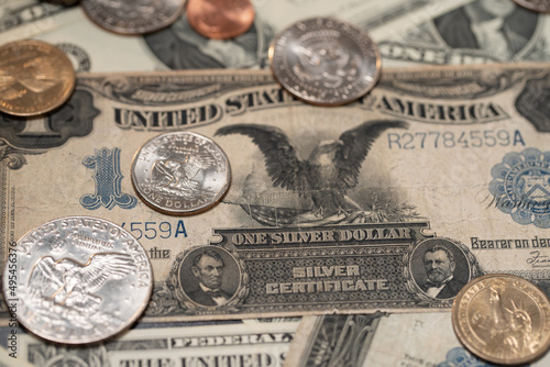 Dollar coins on top of US Dollar banknote. Rare 1 Dollar bill. Black Eagle bill