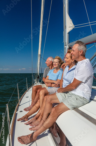Senior friends enjoying luxury lifestyle relaxing on yacht © Spotmatik