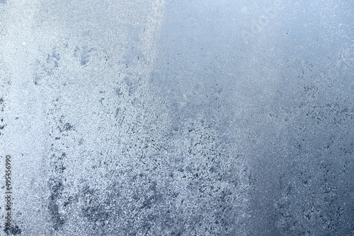 Frosty textured gray background. Ice on the glass close-up