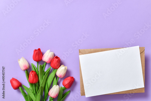 Fototapeta Naklejka Na Ścianę i Meble -  A festive banner with tulips and an envelope on a purple background.