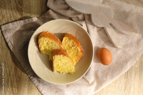 Plate of traditional sweet bread, eaten at Easter time in Croatia. Easter bunny, eggs and flowers on the table. Top view. photo