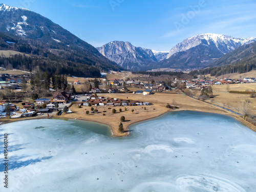 Obraz na płótnie aerial view frozen lake Zenzsee in Styria, Austria.In the background mountain range Hochschwab with peaks Pribitz and Messnerin w salonie