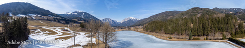 Obraz na płótnie aerial view frozen lake Zenzsee in Styria, Austria.In the background mountain range Hochschwab with peaks Pribitz and Messnerin w salonie