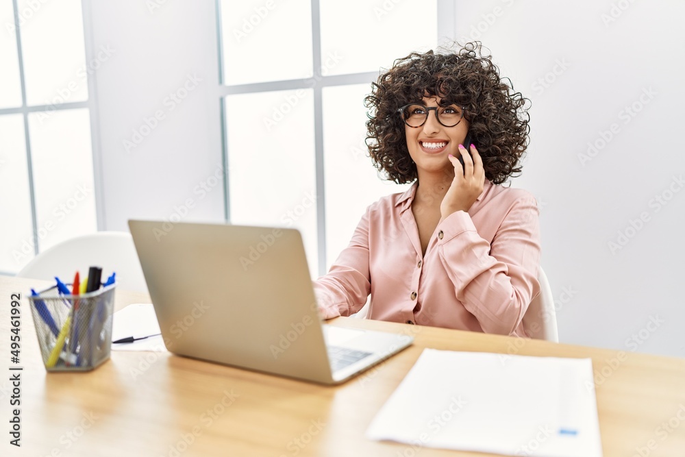 Young middle east businesswoman talking on the smartphone working at the office. Young middle east businesswoman talking on the smartphone working at the office.