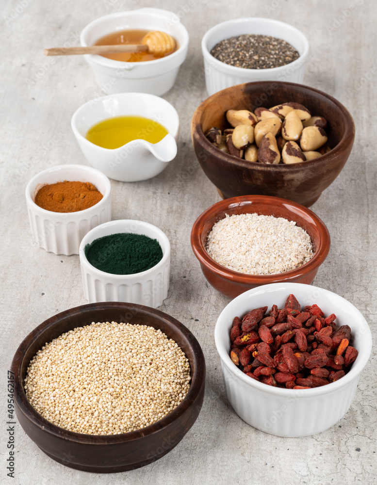 Assorted superfoods in over wooden background. Chia, quinoa, oat, linseed, honey, spirulina and others Assorted superfoods in over wooden background. Chia, quinoa, oat, linseed, honey, spirulina and others