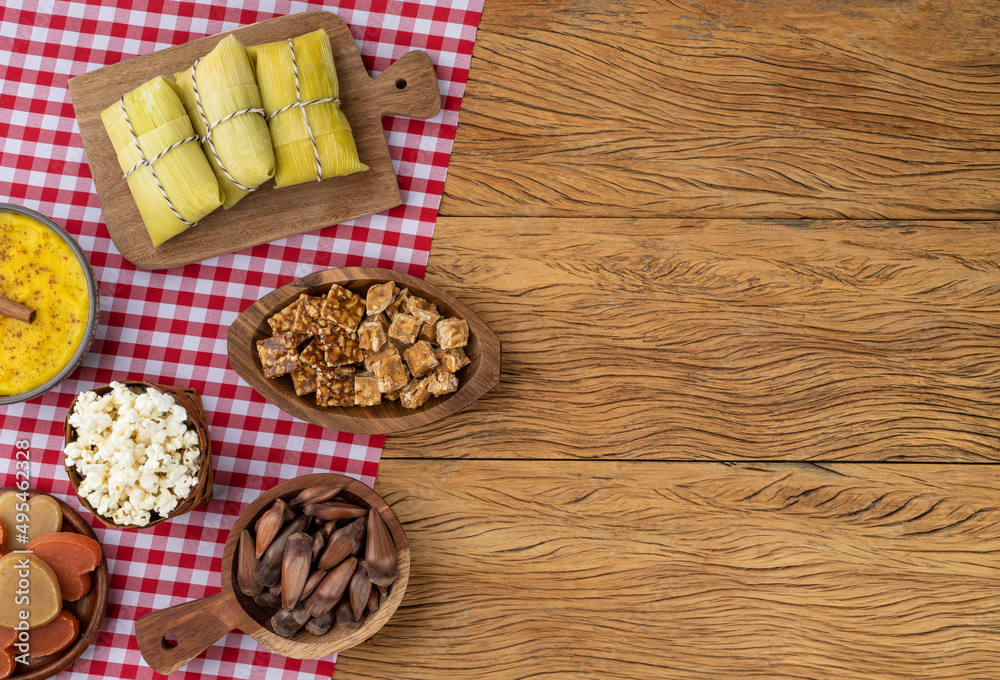 Typical brazilian june festival food over red plaid fabric with copy space. Festa junina