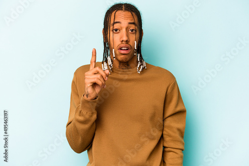 Young African American man isolated on blue background having an idea, inspiration concept.