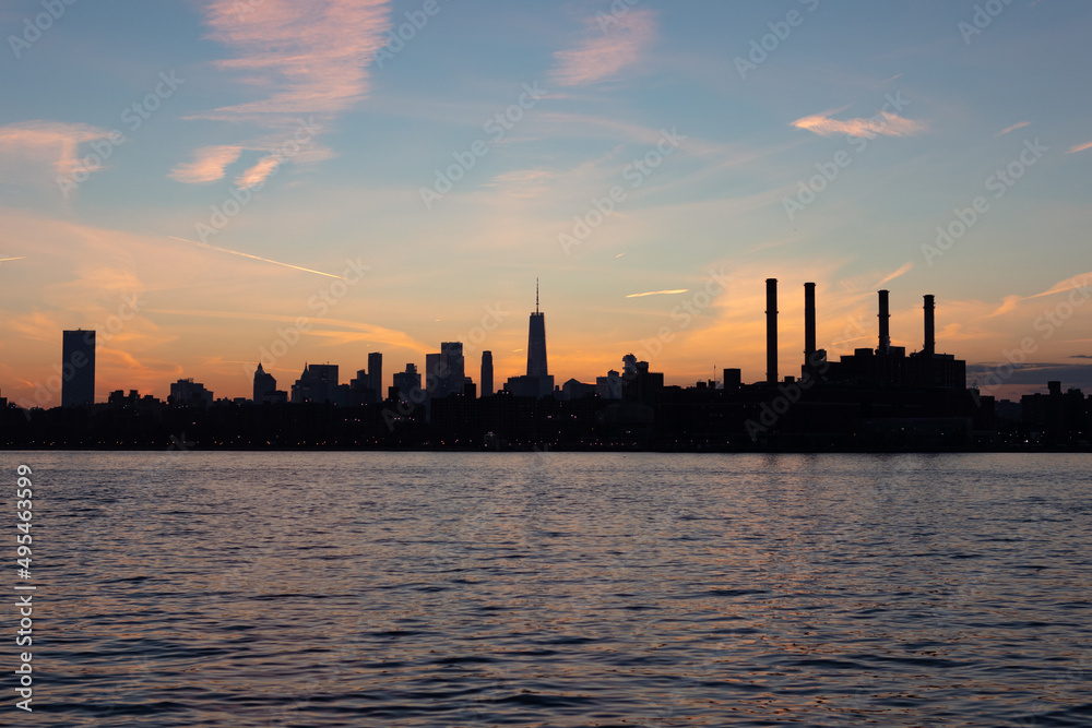 Lower Manhattan Skyline Silhouette during a Colorful Sunset along the East River in New York City