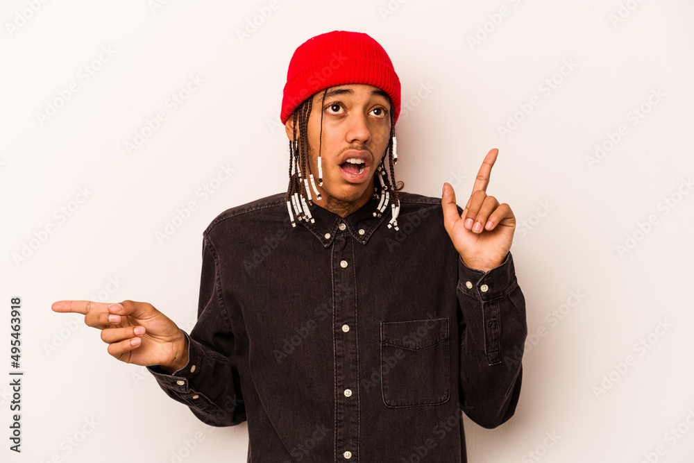 Young African American man isolated on white background pointing to different copy spaces, choosing one of them, showing with finger. Young African American man isolated on white background pointing to different copy spaces, choosing one of them, showing with finger.