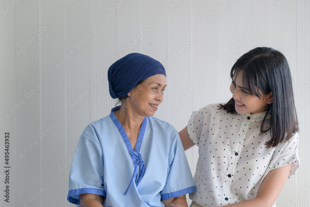 Cancer patient woman wearing head scarf and her supportive daughter in hospital, health and insurance concept. Cancer patient woman wearing head scarf and her supportive daughter in hospital, health and insurance concept.