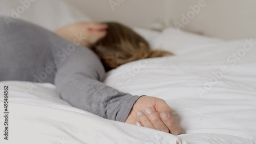The dead woman lies on the bed.