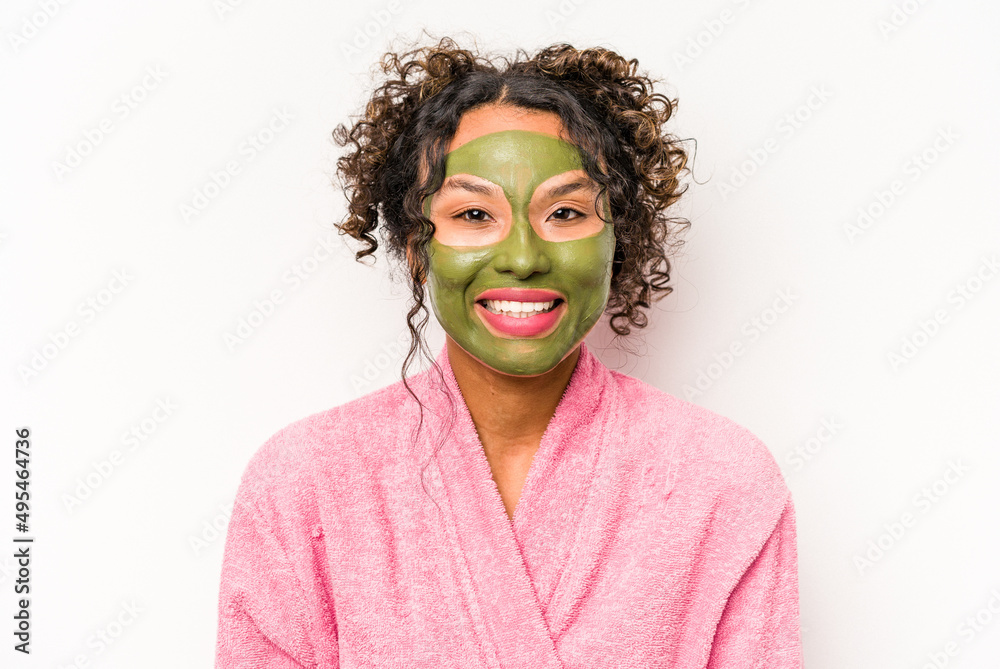 Young hispanic woman wearing a facial mask isolated on white background happy, smiling and cheerful. Young hispanic woman wearing a facial mask isolated on white background happy, smiling and cheerful.