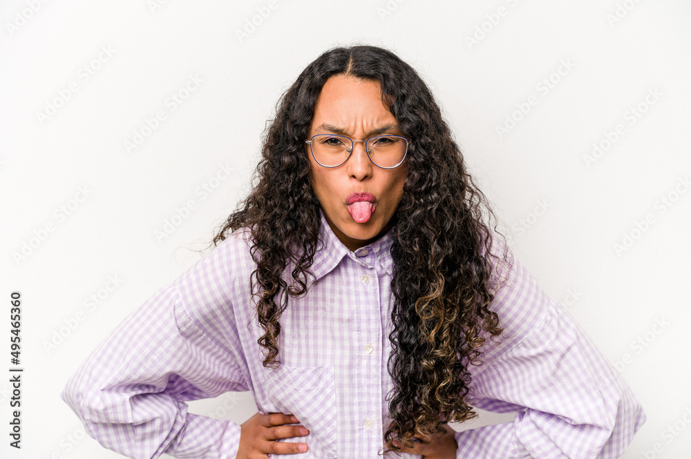 Young hispanic woman isolated on white background funny and friendly sticking out tongue. Young hispanic woman isolated on white background funny and friendly sticking out tongue.