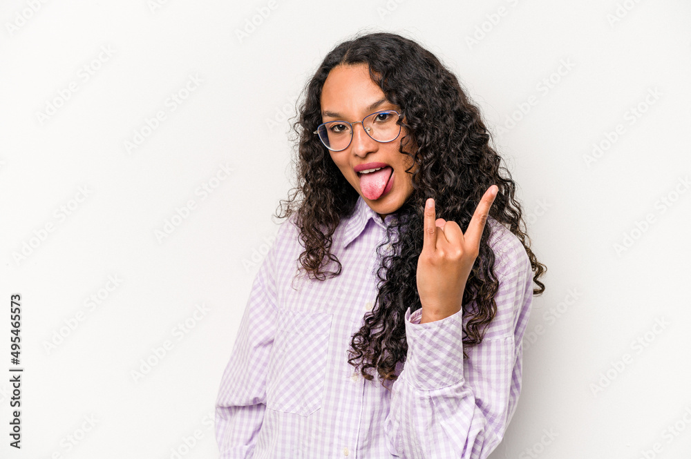 Young hispanic woman isolated on white background showing rock gesture with fingers Young hispanic woman isolated on white background showing rock gesture with fingers