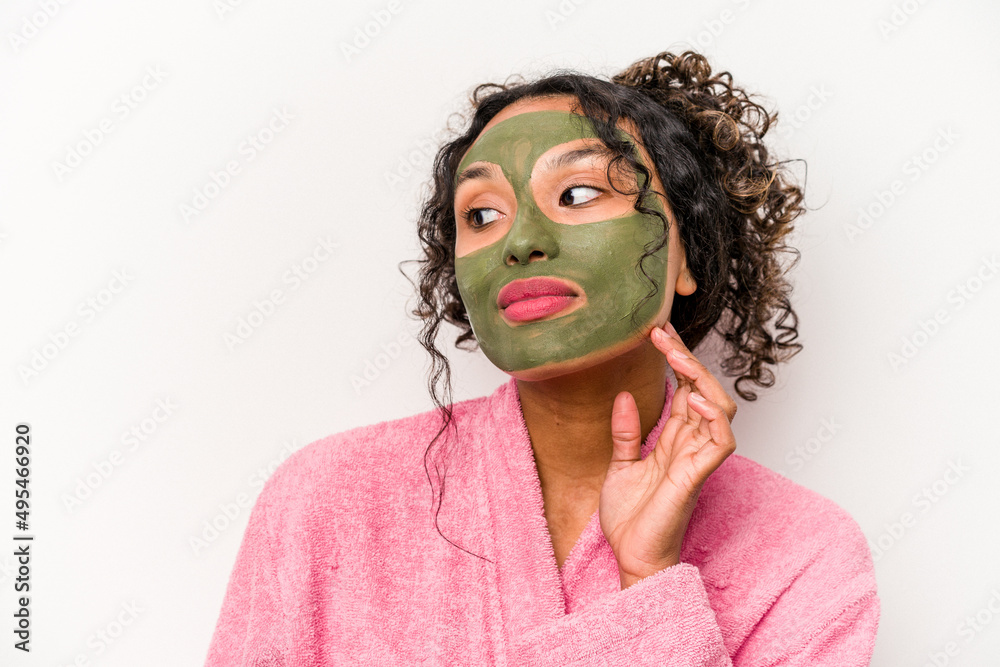 Young hispanic woman wearing a facial mask isolated on white background Young hispanic woman wearing a facial mask isolated on white background