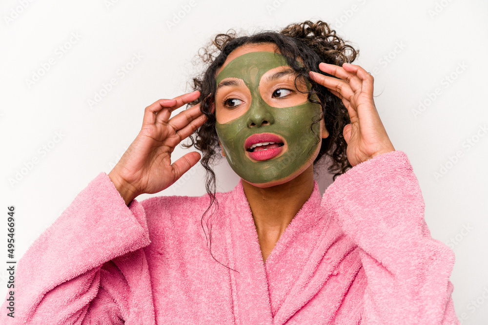 Young hispanic woman wearing a facial mask isolated on white background Young hispanic woman wearing a facial mask isolated on white background