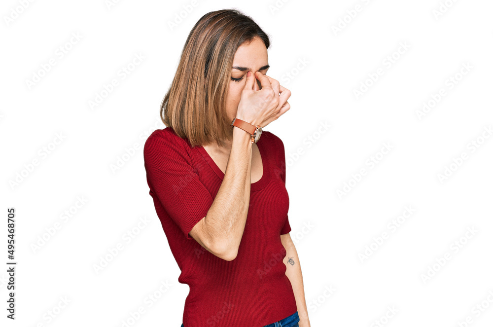 Young blonde girl wearing casual clothes tired rubbing nose and eyes feeling fatigue and headache. stress and frustration concept. Young blonde girl wearing casual clothes tired rubbing nose and eyes feeling fatigue and headache. stress and frustration concept.