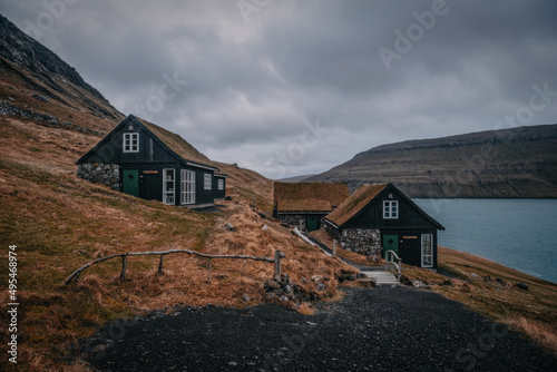 Picturesque view of tradicional faroese grass-covered houses in the village Bour during autumn. Vagar island, Faroe Islands, Denmark. November 2021