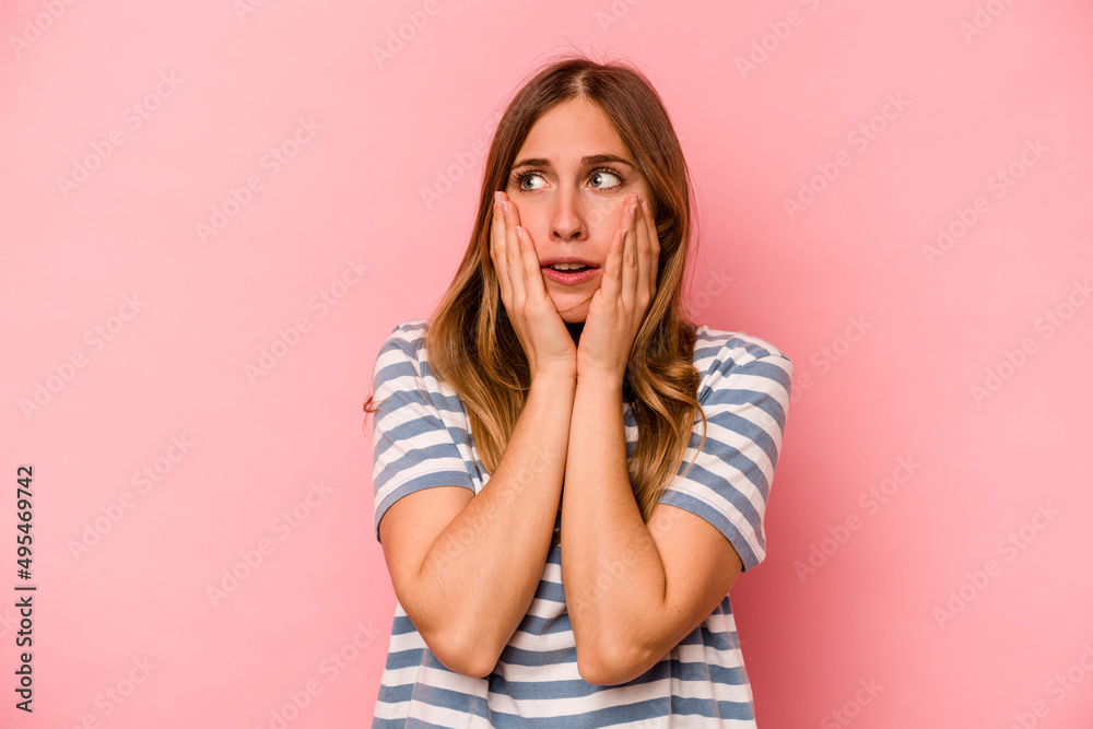 Young caucasian woman isolated on pink background scared and afraid. Young caucasian woman isolated on pink background scared and afraid.