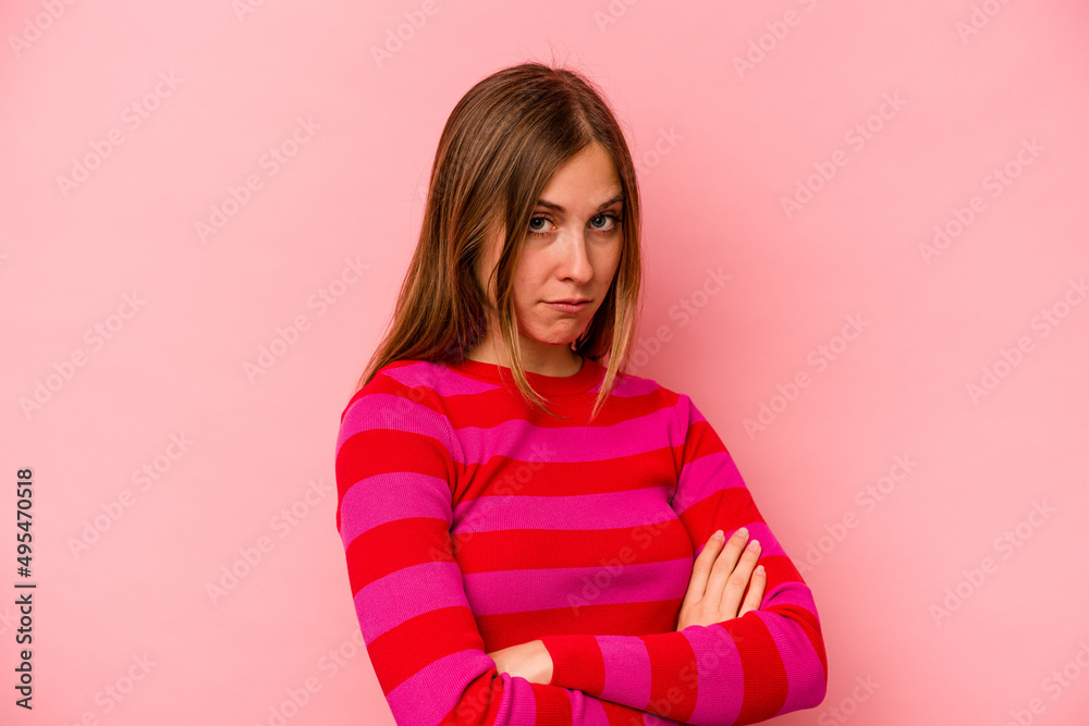Young caucasian woman isolated on pink background suspicious, uncertain, examining you. Young caucasian woman isolated on pink background suspicious, uncertain, examining you.