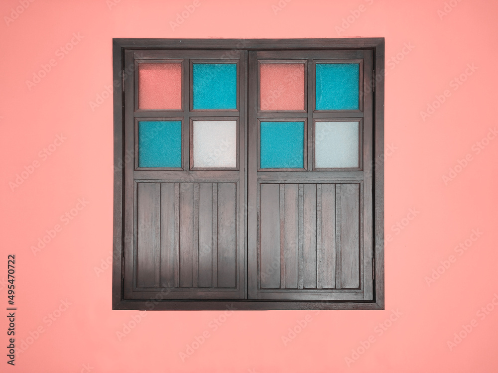 Antique old closed wood window on wall in pastel color. Malay culture style Antique old closed wood window on wall in pastel color. Malay culture style