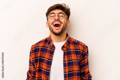 Young hispanic man isolated on white background relaxed and happy laughing, neck stretched showing teeth.