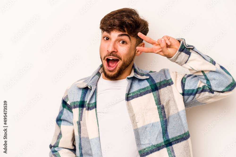 Young hispanic man isolated on white background dancing and having fun.