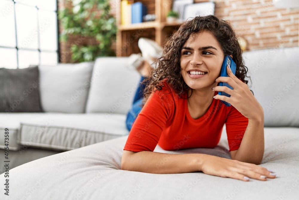 Young latin woman smiling confident talking on the smartphone at home Young latin woman smiling confident talking on the smartphone at home