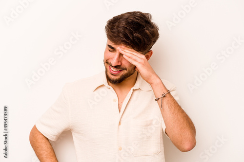 Young hispanic man isolated on white background joyful laughing a lot. Happiness concept.