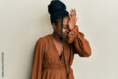 African american woman with braided hair wearing casual brown shirt surprised with hand on head for mistake, remember error. forgot, bad memory concept. © Krakenimages.com