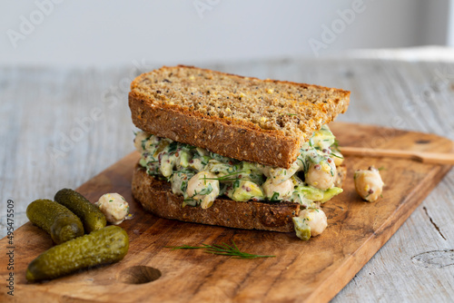 Fotografie Creamy chickpea salad with avocado, dill, onion and mustard sauce on home made b