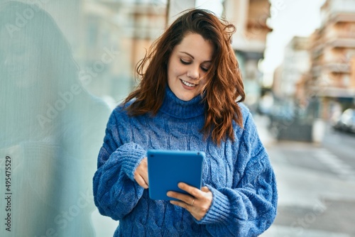 Young irish plus size girl using touchpad at the city.