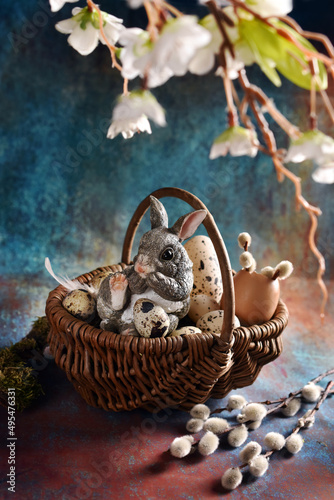 Easter still life with wicker basket and sitting bunny figurine © teressa