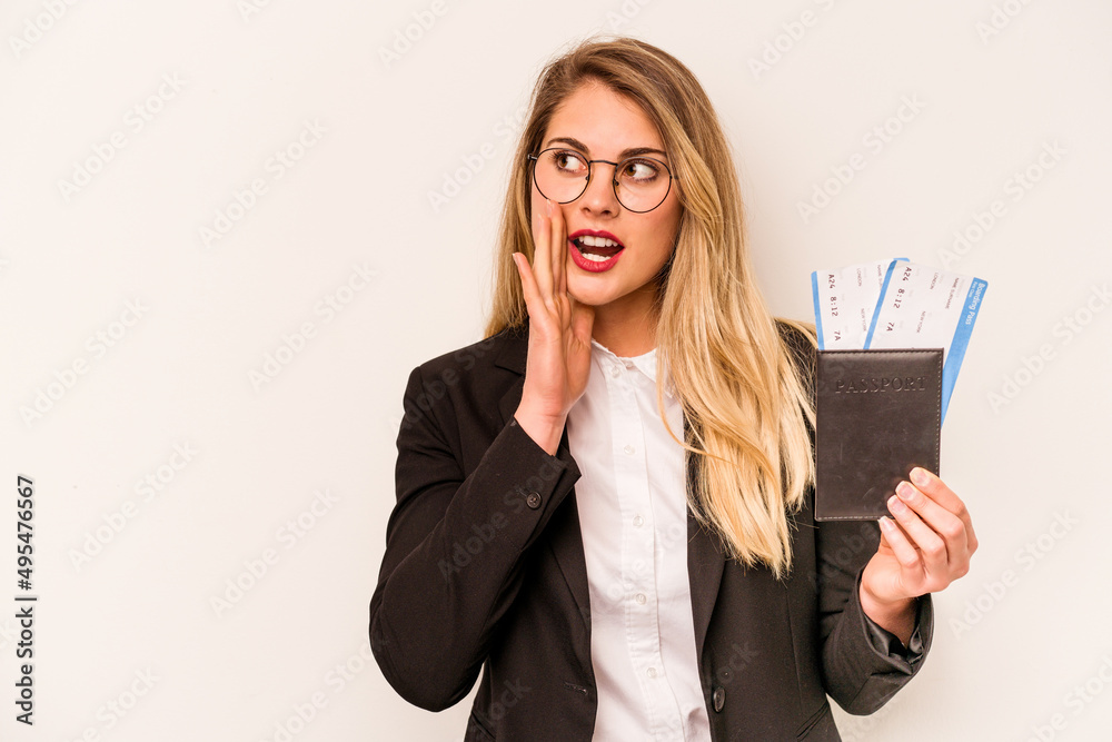 Young business caucasian woman holding a passport isolated on white background is saying a secret hot braking news and looking aside Young business caucasian woman holding a passport isolated on white background is saying a secret hot braking news and looking aside