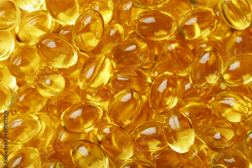 Golden Vitamin D3 Capsules close-up in full screen