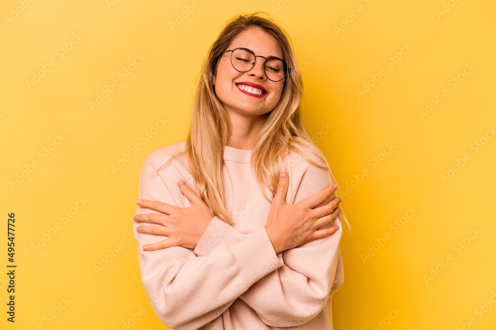 Young caucasian woman isolated on yellow background laughing and having fun. Young caucasian woman isolated on yellow background laughing and having fun.