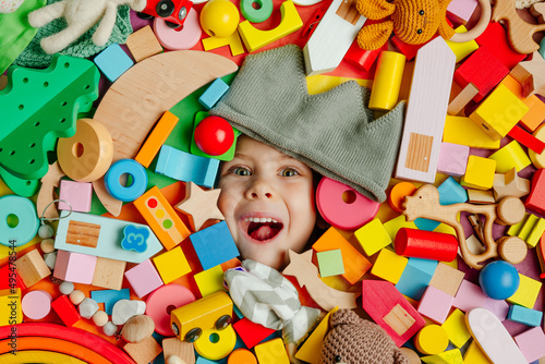 Child's face in the plenty of wooden toys