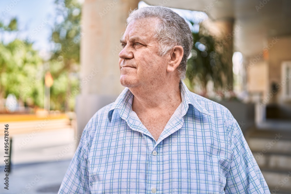 Middle age grey-haired man smiling confident walking at street Middle age grey-haired man smiling confident walking at street