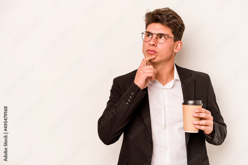 Young caucasian business man holding takeaway coffee isolated on white background looking sideways with doubtful and skeptical expression. Young caucasian business man holding takeaway coffee isolated on white background looking sideways with doubtful and skeptical expression.