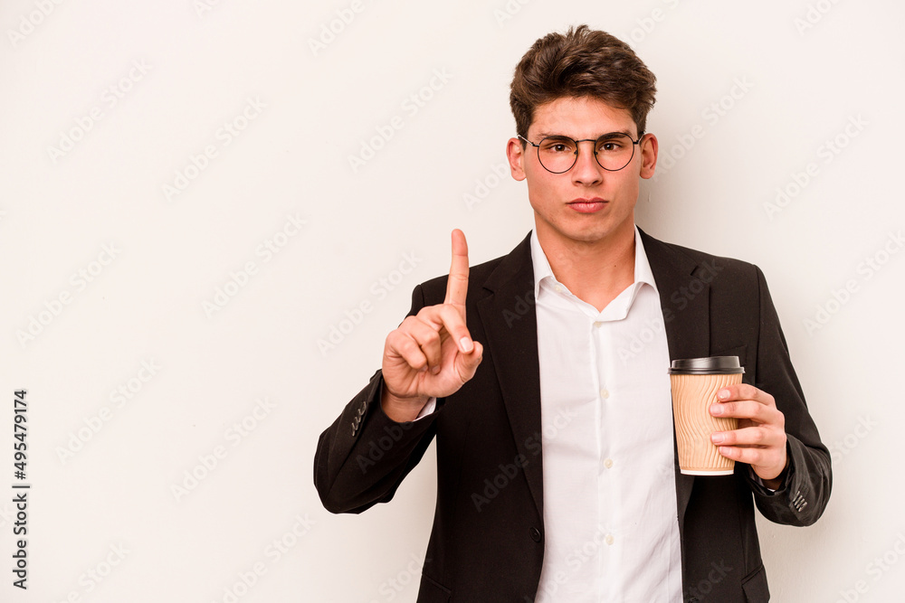 Young caucasian business man holding takeaway coffee isolated on white background showing number one with finger. Young caucasian business man holding takeaway coffee isolated on white background showing number one with finger.