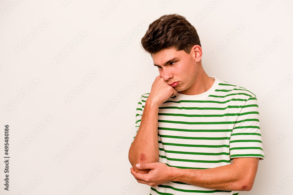 Young caucasian man isolated on white background who feels sad and pensive, looking at copy space. Young caucasian man isolated on white background who feels sad and pensive, looking at copy space.