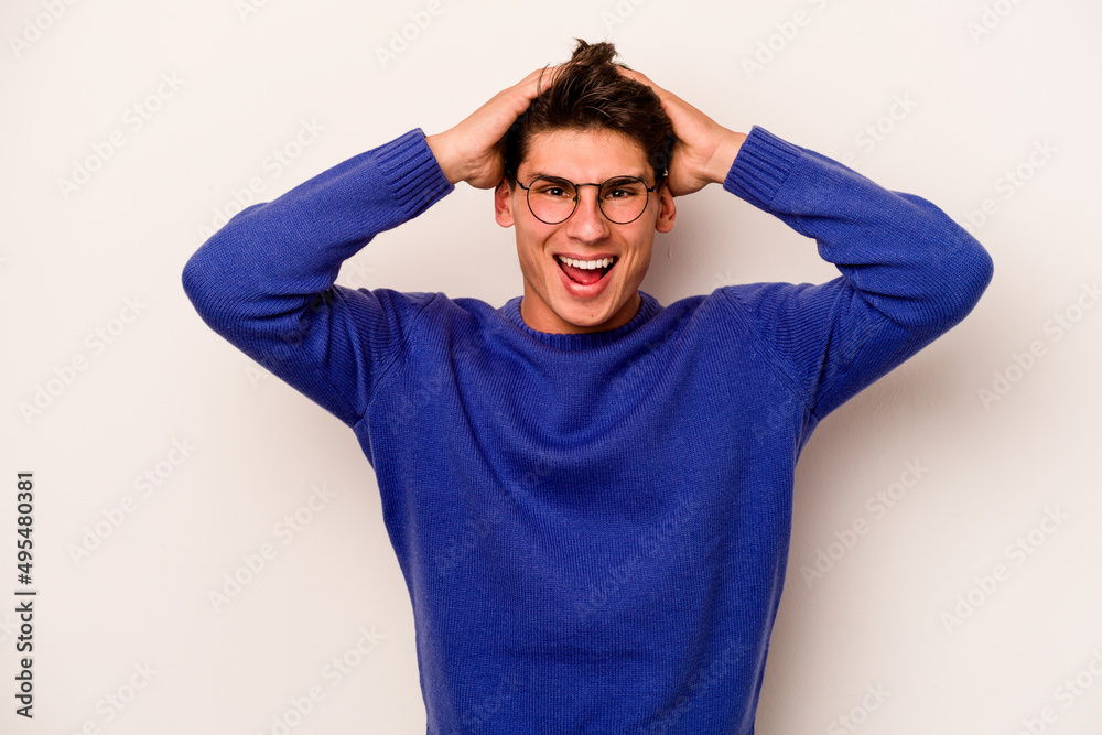 Young caucasian man isolated on white background screaming, very excited, passionate, satisfied with something.
