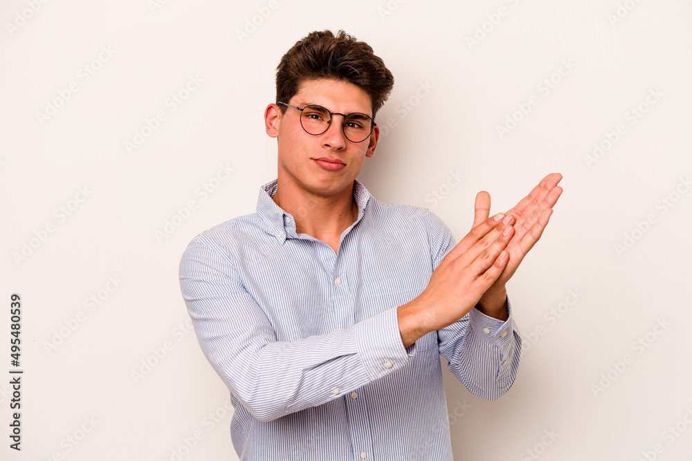 Young caucasian man isolated on white background feeling energetic and comfortable, rubbing hands confident.