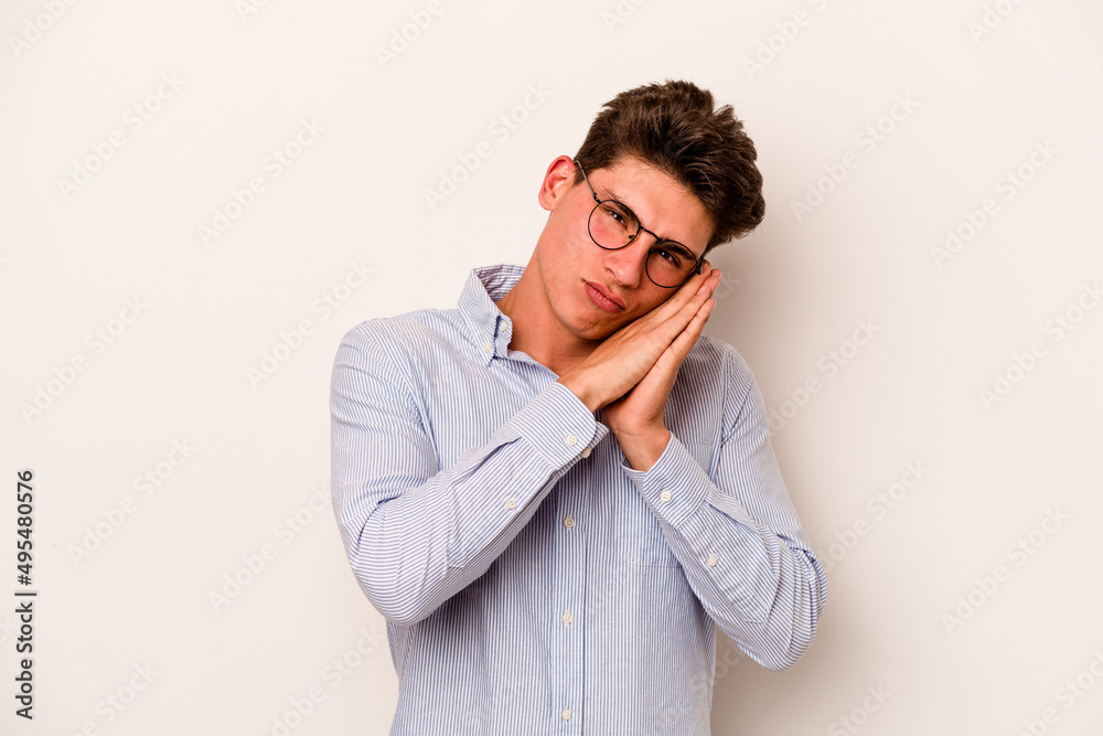 Young caucasian man isolated on white background yawning showing a tired gesture covering mouth with hand. Young caucasian man isolated on white background yawning showing a tired gesture covering mouth with hand.