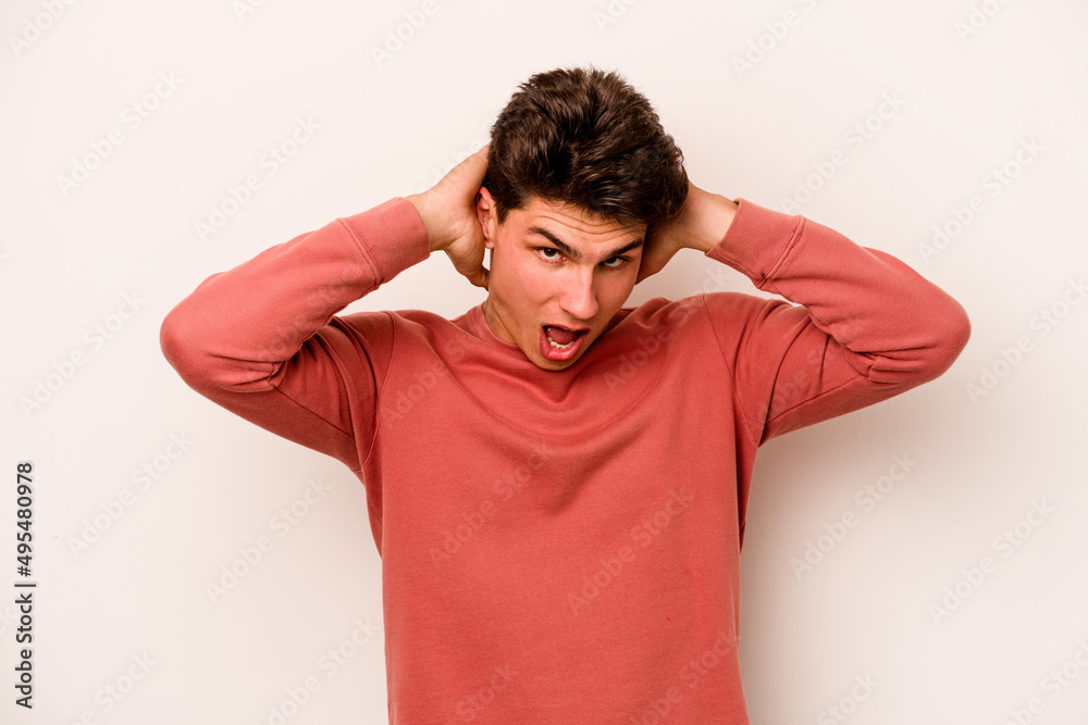 Young caucasian man isolated on white background screaming, very excited, passionate, satisfied with something.