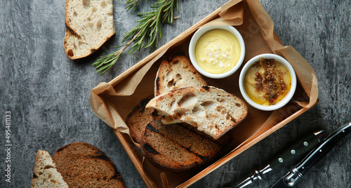 Bread snacks. Toasted bread, croutons with sauce and rosemary on a gray background. White and black bread. Restaurant menu. Rustic. Background image, copy space. Flatlay, top view