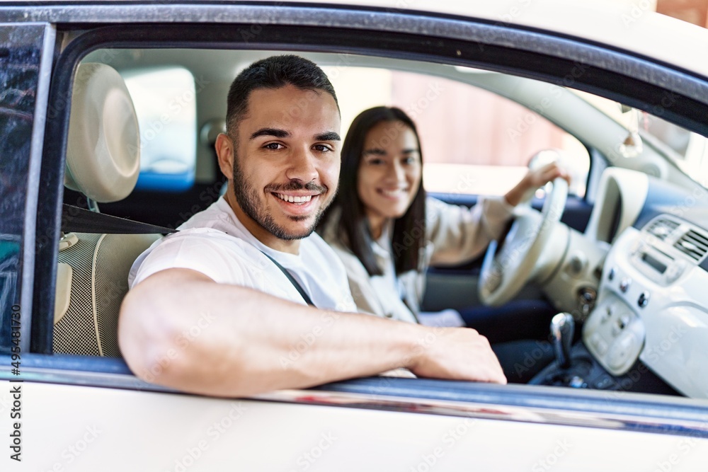 Young hispanic couple smiling happy driving car at the city. Young hispanic couple smiling happy driving car at the city.