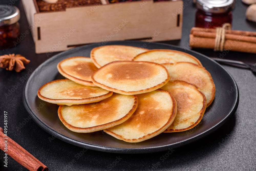 Delicious fresh pancakes on a wooden cutting board with sugar Delicious fresh pancakes on a wooden cutting board with sugar